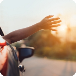 Hand outside vehicle window. 